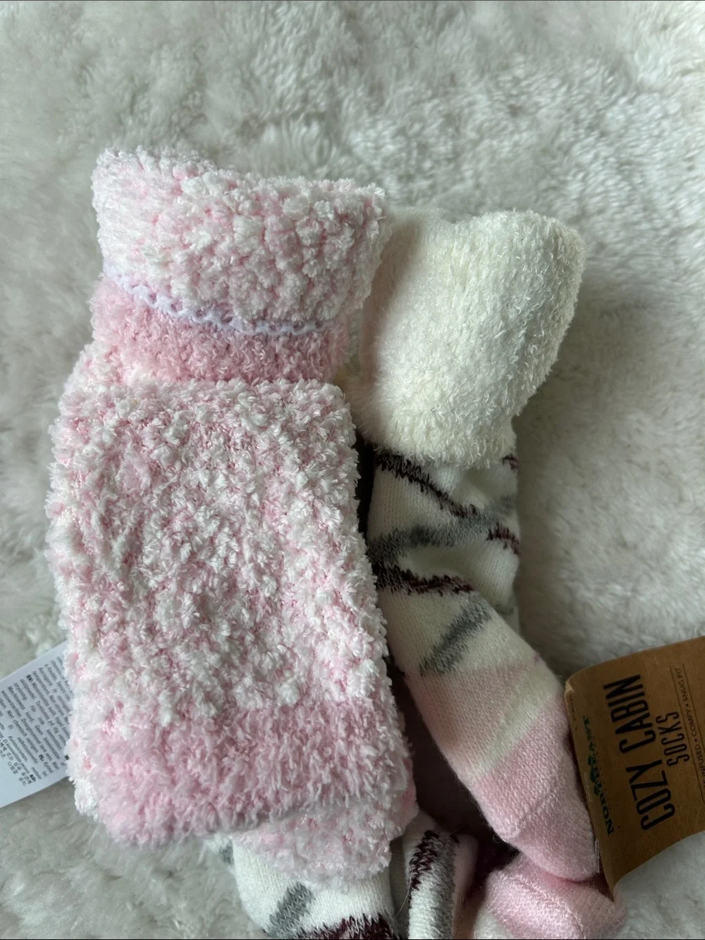 Pair of cozy socks: UGG Women's Light Pink Plush & Northeast Outfitters